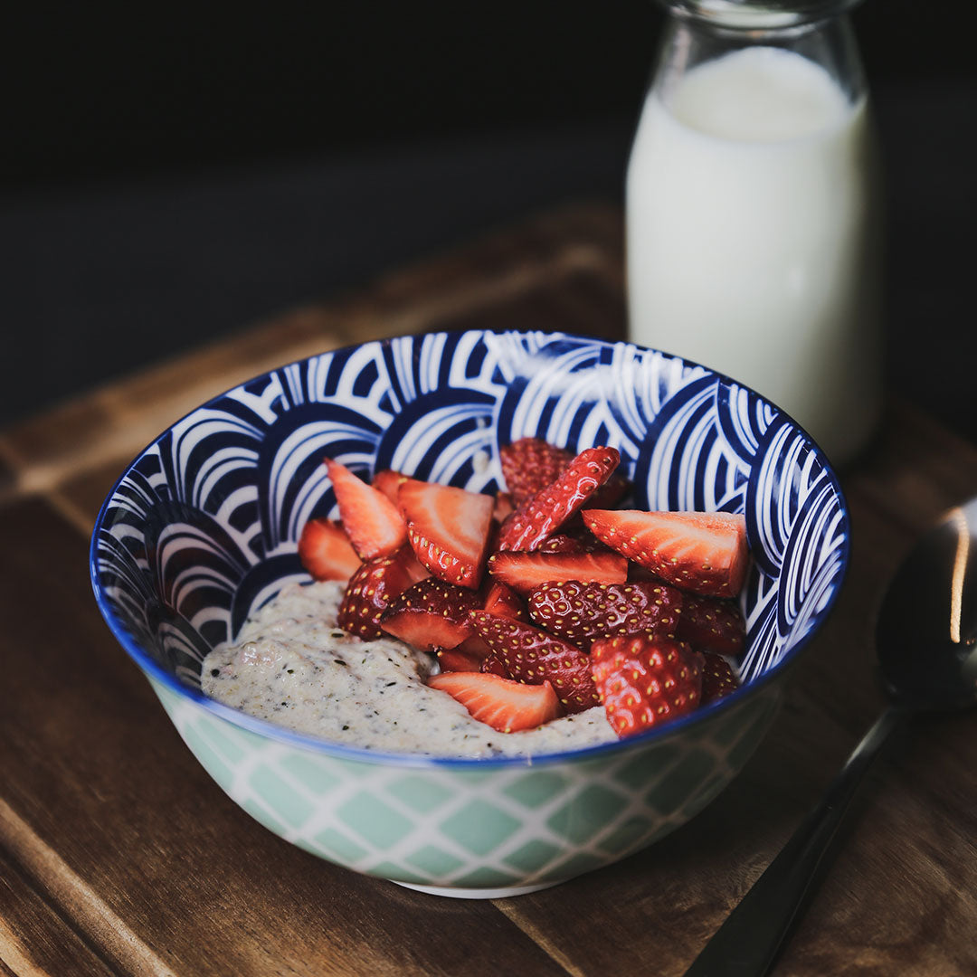 Bowl of strawberry keto oatmeal garnished with strawberries